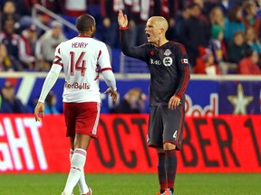 Toronto FC midfielder Michael Bradley (4) argues with the referee as New York Red Bulls forward Thierry Henry (14) tries to step in between during the second half at Red Bull Arena. (Adam Hunger-USA TODAY Sports)
