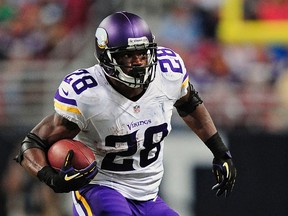 Minnesota Vikings running back Adrian Peterson carries the ball against the St. Louis Rams during their NFL football game in St. Louis, Missouri, in this September 7, 2014 file photo. (Jeff Curry/ USA TODAY Sports)