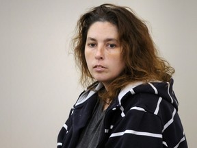 Erika Murray, who was arrested after the bodies of three dead infants were found in her home in the town of Blackstone, sits in the district court for her arraignment in Uxbridge, Massachusetts  September 12, 2014. (REUTERS/Paul Kapteyn/Pool)
