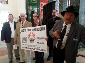 Mark Scharfe (right), candidate in Osgoode ward and spokesman for the Ottawa Property Owners slate, explains why the candidates want an elected hydro commissioner at City Hall on Tuesday, Oct. 14, 2014. JON WILLING/OTTAWA SUN