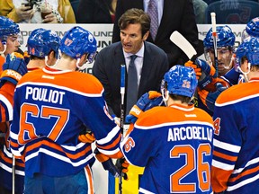 Edmonton's head coach Dallas Eakins talks to his players during the third period of the Edmonton Oilers' NHL hockey game against the Calgary Flames at Rexall Place in Edmonton, Alta., on Thursday, Oct. 9, 2014. The Flames won 5-2. Codie McLachlan/Edmonton Sun/QMI Agency