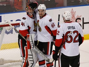 Ottawa Senators goalie Craig Anderson is congratulated by  right wing Mark Stone (61) and defenceman Eric Gryba (62) after defeating the Florida Panthers 1-0 at BB&T Center. (Robert Mayer-USA TODAY Sports)