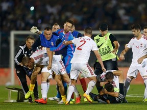 Fans and players of Serbia and Albania clash during their Euro 2016 Group I qualifying match in Belgrade on Tuesday, Oct. 14, 2014. (Marko Djurica/Reuters)