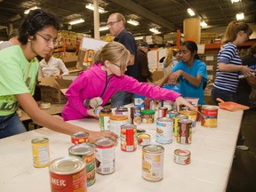 Volunteers spend Thanksgiving Day sorting food at the London Food Bank in London, Ontario on Monday, October 13, 2014.  (DEREK RUTTAN, Free Press file photo)