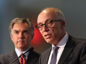 Alberta Premier Jim Prentice (l) listens as Health Minister, Stephen Mandel (r) announce measures to ease pressure on provincial hospitals by addressing the needs of more than 700 senior or complex needs patients during a news conference at Robbins Pavilion at the Royal Alexandra Hospital in Edmonton, Alberta on Monday, October 14, 2014.  Perry Mah/Edmonton Sun