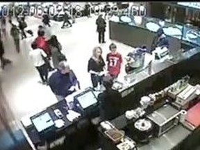 Christopher Husbands, far right, is seen with girlfriend La Chelle John, second from right, at Sushi Q in the Eaton Centre before the shooting in which Connor Stevenson, 13, in red T-shirt, was shot in the head. (Screengrab)