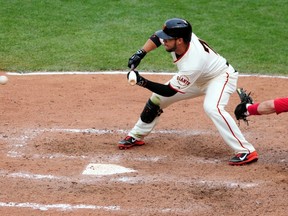 San Francisco Giants centre fielder Gregor Blanco hits a sacrifice bunt that let to the game winning run in the 10th inning against the St. Louis Cardinals during Game 3 of the 2014 NLCS at AT&T Park on October 14, 2014. (Ed Szczepanski/USA TODAY Sports)