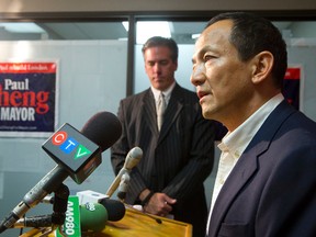 Roger Caranci listens to Paul Cheng after announcing he is stepping down from his mayoral race and throwing his support behind Cheng at a press conference at Cheng's Wellington Road campaign headquarters in London on Tuesday October 14, 2014. (CRAIG GLOVER, The London Free Press)