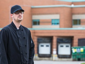 Chris Sroka poses outside of Markham Stouffville Hospital - the morgue is to the left of the doors - in Markham on Tuesday, October 14, 2014. (Ernest Doroszuk/Toronto Sun)