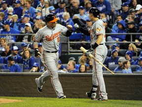 Baltimore Orioles first baseman Steve Pearce (28) celebrates with third baseman Ryan Flaherty (3) after scoring a run against the Kansas City Royals during the second inning in Game 3 of the ALCS on Oct. 14. (John Rieger-USA TODAY Sports)