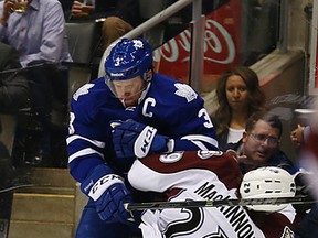 Maple Leafs captain Dion Phaneuf lowers the boom on the Avalanche’s Nathan MacKinnon at the Air Canada Centre Tuesday night. Phaneuf was a plus-2 on the night. (Michael Peake/Toronto Sun)