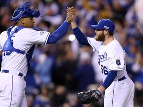 Greg Holland of the Kansas City Royals celebrates with catcher Salvador Perez after closing out the ninth inning to defeat the Baltimore Orioles in Game 3 of the ALCS at Kauffman Stadium on October 14, 2014. (Ed Zurga/Getty Images/AFP)