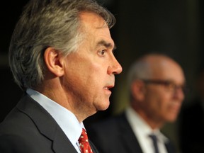Alberta Premier Jim Prentice, with Health Minister Stephen Mandel, announces measures to ease pressure on provincial hospitals by addressing the needs of more than 700 senior or complex needs patients during a news conference at Robbins Pavilion at the Royal Alexandra Hospital in Edmonton, Alberta on Monday, October 14, 2014.  
Perry Mah/Edmonton Sun/QMI Agency