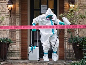 A member of the CG Environmental HazMat team disinfects the entrance to the residence of a health worker at the Texas Health Presbyterian Hospital who has contracted Ebola in Dallas, Texas, October 12, 2014. (REUTERS/Jaime R. Carrero)