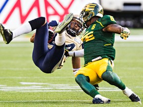 Eskimos CB Alonzo Lawrence limited Bombers receiver Romby Bryant to a couple of yards with this third-quarter hit. (Codie McLachlan, Edmonton Sun)