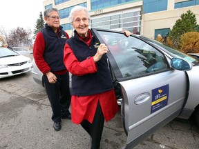Carl Nishmura helps senior Margaret Geary out of the car for the LIFT news conference at AMA in  Edmonton, Alberta on Wednesday, October 15, 2014.  LIFT is an assisted transportation service for seniors.Perry Mah/Edmonton Sun/QMI Agency