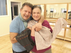 Ebon Gage, from the Kingston School of Dance, left, and Dorothy Young, from the Kingston Handloom Weavers and Spinners, hold up some of the clothing that will be part of a unique fashion show next month. (Michael Lea/The Whig-Standard)