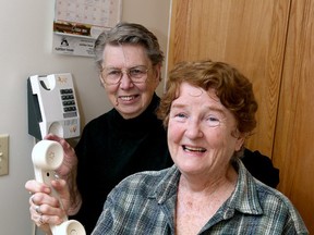 Jacquline Charlebois, holding phone, and her friend Rita Kutchaw, want to vote by phone in the coming municipal election but have to register on the Internet before they can vote, but neither senior owns a computer. (Ian MacAlpine/The Whig-Standard)