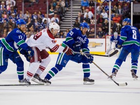 Vancouver Canucks forwards Daniel (22) and Henrik Sedin (33) battle with Arizona Coyotes winger Shane Doan during a pre-season game. (USA Today Sports)