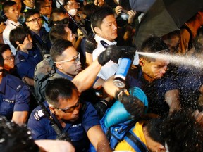 Police use pepper spray as they clash with pro-democracy protesters at an area near the government headquarters building in Hong Kong early October 16, 2014.   REUTERS/Carlos Barria