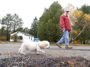 Gino Donato/The Sudbury Star
Erich Grosser walks his dog Shorty in Dowling, which is in Ward 3, on Wednesday afternoon. Ward 3 encompasses Chelmsford, Onaping, Dowling and Levack.