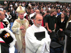 Bishop Ronald Fabbro of London follows Deacon Chuck Stevens to the stage in the gym at St. Patrick's Catholic High School Thursday for a mass celebrated for the Sarnia school's official opening following $14.6-million in renovations. The school also scheduled a public open house Thursday from 4 p.m. to 7 p.m. PAUL MORDEN/THE OBSERVER/QMI AGENCY