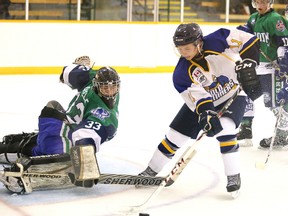 Kirkland Lake Goldminers Steven Babin tries to control the puck around Sudbury Nickel Barons goalie Kevin Labelle during second period NOJHL action from the McClelland Arena on Wednesday night.