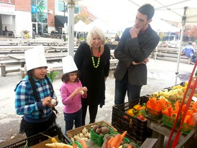 Deb Matthews, MPP for London North Centre (middle) and Andrew Fleet, executive director of Growing Chefs! Ontario, shop for vegetables with students from Byron Northview public school at Covent Garden Market in London, Ont. October 16, 2014. CHRIS MONTANINI\LONDONER\QMI AGENCY