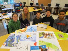The Grade 7 and 8 class at Saint-Francois-Xavier, a French language school in Sarnia, is working to raise $850 to provide a source of clean drinking water for a village in India. From left, those involved in the project include Raquell Silverthorne, 12, teacher Marie-Claude Blouin, Bence Esztegar, 13, Kodee Noel, 13, and Mac Moffatt, 13. PAUL MORDEN/THE OBSERVER/QMI AGENCY