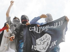 Kashmiri demonstrators hold up a flag of the Islamic State of Iraq and the Levant (ISIL) during a demonstration against Israeli military operations in Gaza in July. Bob Ripley says critics should fear being branded racist or Islamophobic for speaking out against the Islamic State. (Tauseef Mustafa/AFP Photo)
