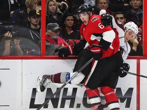 Ottawa Senators' Bobby Ryan battles with Colorado Avalanches' Tyson Barrie during NHL hockey action at the Canadian Tire Centre in Ottawa, Ontario on Thursday October 16, 2014. Errol McGihon/Ottawa Sun/QMI Agency