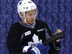Leafs’ impressive young defenceman Stuart Percy fixes his stick at practice on Thursday. The youngster’s strong play on the blue line has been the Leafs’ most pleasant surprise this season. (Craig Robertson/Toronto Sun)