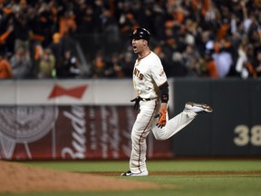 San Francisco Giants left fielder Travis Ishikawa hits a walk off three-run home run against the St. Louis Cardinals during the ninth inning of Game 5 of the 2014 NLCS at AT&T Park on October 16, 2014. (Kyle Terada/USA TODAY Sports)