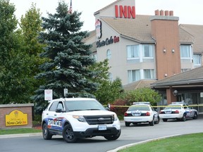 Investigators at the scene of a police shooting at the Monte Carlo Inn on South Service Rd. in Oakville Friday, Oct.. 17, 2014. (Andrew Collins photo)