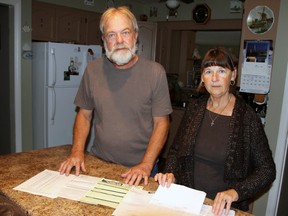 Henry and Lorraine Klein look over some of the paperwork from the sale of a furnace to their family friends by Ontario Energy Group. The Kleins want to warn seniors about inviting salesmen into their homes and signing lengthy contracts. (Dan Dakin/QMI Agency)