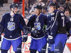 Calgary Flames Jarome Iginla (middle) celebrates a goal by teammate Corey Perry (left) with Pittsburgh Penguins Evgeni Malkin (71) during the NHL All-Star hockey game in Ottawa January 29, 2012. (REUTERS/Blair Gable)