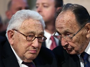 Former German Foreign Minister Hans-Dietrich Genscher (R) chats with former US secretary of state Henry Kissinger at Saint Nikolai church in Leipzig on October 9, 2014 during the 25th anniversary  of one of the most dramatic mass protests in the run-up to the Berlin Wall's fall. AFP PHOTO / RONNY HARTMANN