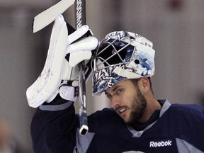 Winnipeg Jets goalie Ondrej Pavelec adjusts his helmet during practice this week. Brian Donogh/Winnipeg Sun/QMI Agency