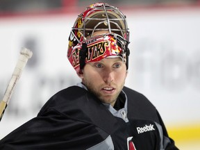 Ottawa Senators goalie Craig Anderson takes a break during practice at Canadian Tire Centre on Friday.  (Tony Caldwell/Ottawa Sun)