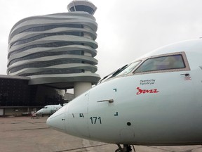 An Air Canada Jazz. Bombardier CRJ 200 sits outside the new control tower at the Edmonton International Airport as travelers board the plane on their way to Winnipeg, Manitoba. Tom Braid/Edmonton Sun/QMI Agency