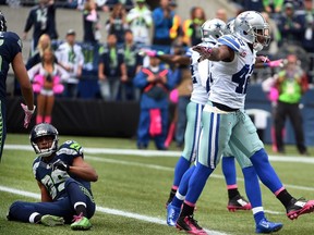 Free safety Barry Church #42 of the Dallas Cowboys celebrates after breaking up a pass intended for wide receiver Doug Baldwin #89 of the Seattle Seahawks. Steve Dykes/Getty Images/AFP