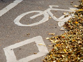 Now you see them, now you don't? A bike lane sign is seen on 106 Street southbound at 70 Avenue in Edmonton, Alta., on Saturday, Oct. 11, 2014. City council is now reconsidering how bike lanes are picked and constructed around the city. Ian Kucerak/Edmonton Sun/ QMI Agency