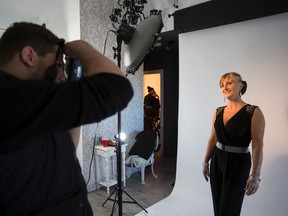 Jacqui Derewlanka gets her photo taken by photographer John Mio during Break the Cycle's Model for a Day at Nare Studios in Edmonton, Alta., on Saturday, Oct. 18, 2014. The event was held in recognition of Domestic Violence Awareness Month. Ian Kucerak/Edmonton Sun/ QMI Agency