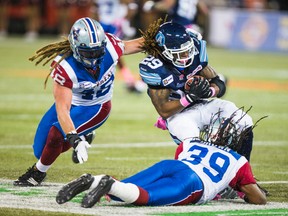 Argonauts' Curtis Steele and Montreal Alouettes' Bear Woods (left) get tangled up during Saturday's CFL action at the Rogers Centre. (Ernest Doroszuk/Toronto Sun)