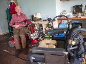 Eric Law sits in his motorized scooter in his apartment that he shares with his wife, Tammy White. Law's home care services are expected to be cut and he has very few alternatives to turn to.
DANI-ELLE DUBE/Ottawa Sun/QMI AGENCY