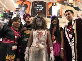 Joanna Delos Reyes (left) the head Halloween costume consultant at the Value Village on Ellice Avenue, and staff including Edmerlyn Tiglao, Karen Navarro, Ella Perez and Brandon Boroska (from left), are ready to assist in your costume needs on Sat., Oct. 18, 2014.