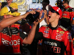 Brad Keselowski guzzles champagne after winning the NASCAR Sprint Cup Series GEICO 500 at Talladega Superspeedway on Sunday in Alabama. (AFP/PHOTO)