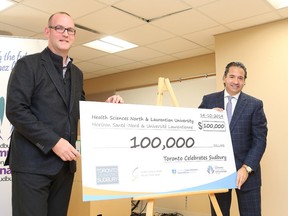 Gino Donato/The Sudbury Star    
Jamie Lamont and Perry Dellelce, co-chairs of Toronto Celebrates Sudbury, unveil a cheque for $100,000 donated to Health Sciences North and Laurentian University.