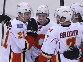 Mason Raymond, Johnny Gaudreau, TJ Brodie and Mikael Backlund (from left) of the Calgary Flames celebrate Brodie's third period goal against the Winnipeg Jets during NHL action at MTS Centre in Winnipeg, Man., on Sun., Oct. 19, 2014. Kevin King/Winnipeg Sun/QMI Agency