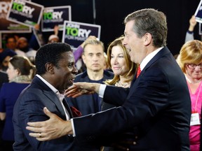 Football great Mike "Pinball" Clemons steps up to embrace Toronto mayoral candidate John Tory last night at a fundraising dinner.(MICHAEL PEAKE/Toronto Sun)